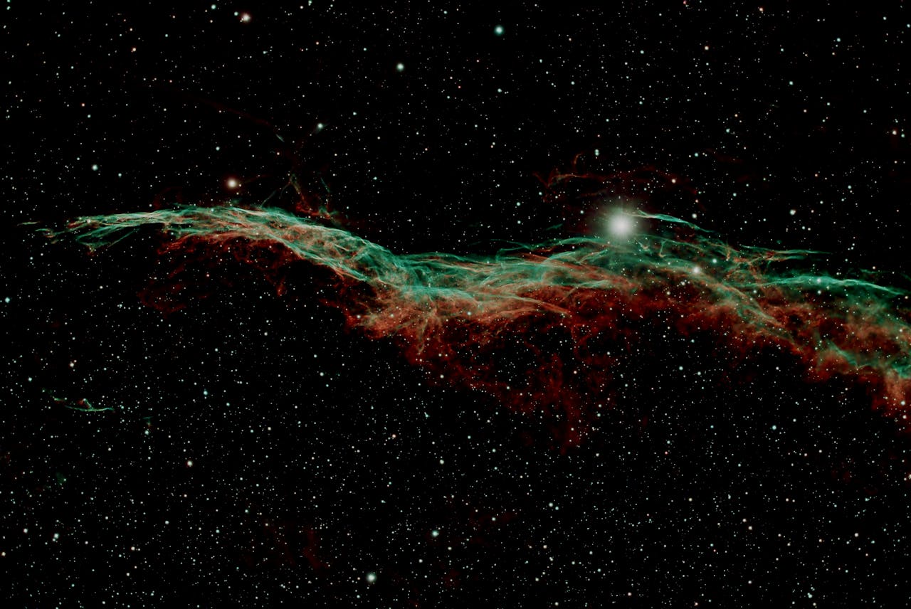 brand-02 Captivating view of the Veil Nebula glowing amidst distant stars in deep space.