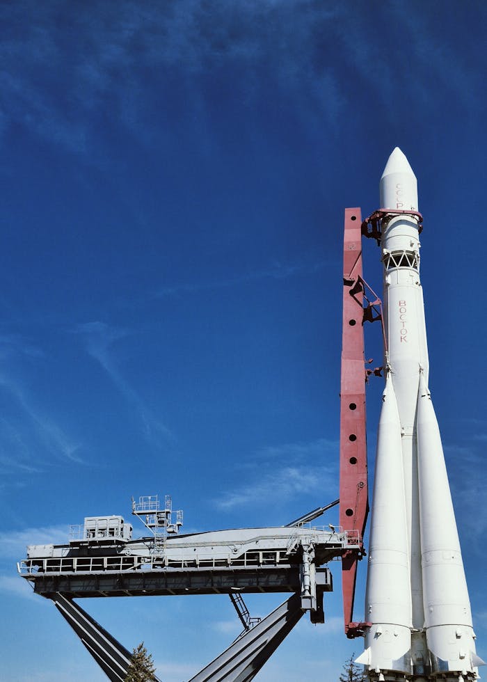 A rocket ready for launch under a vibrant blue sky, showcasing aerospace engineering.