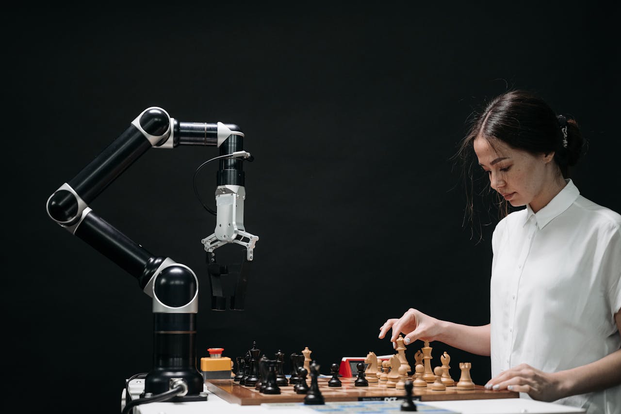 brand-03 A woman plays chess against a robotic arm, showcasing AI innovation in a modern setting.